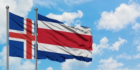 Iceland and Costa Rica flag waving in the wind against white cloudy blue sky together. Diplomacy concept, international relations.