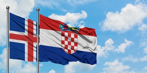 Iceland and Croatia flag waving in the wind against white cloudy blue sky together. Diplomacy...