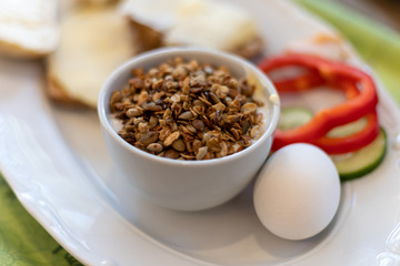Picture of healthy breakfast with eggs, vegetables and cup of porridge in the cafe