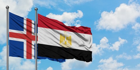 Iceland and Egypt flag waving in the wind against white cloudy blue sky together. Diplomacy concept, international relations.