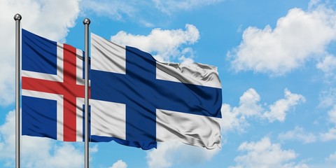 Iceland and Finland flag waving in the wind against white cloudy blue sky together. Diplomacy...