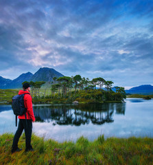 Fototapeta na wymiar Young hiker at the Pine Island in Derryclare Lough