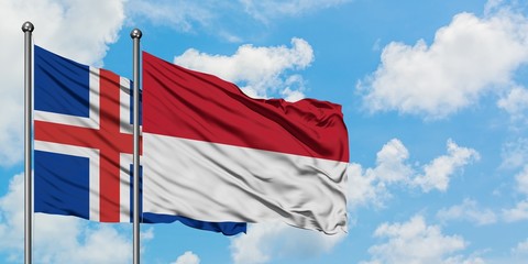 Iceland and Indonesia flag waving in the wind against white cloudy blue sky together. Diplomacy concept, international relations.