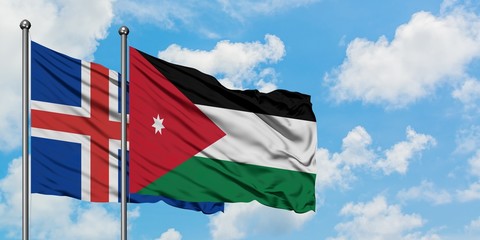 Iceland and Jordan flag waving in the wind against white cloudy blue sky together. Diplomacy concept, international relations.