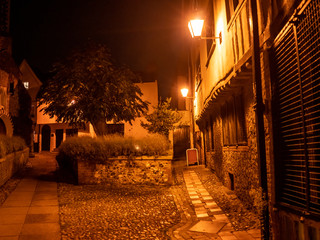 Medieval courtyard at dark illuminated by artificial street lights