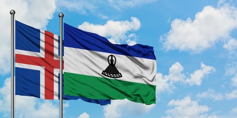 Iceland and Lesotho flag waving in the wind against white cloudy blue sky together. Diplomacy concept, international relations.