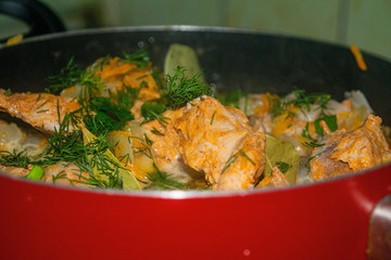 Meat with onions, carrots, dill and Bay leaf is stewed in a saucepan. Home cooking.