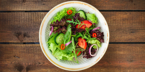 Healthy salad, leaves mix salad (mix micro greens, cucumber, tomato, onion, other ingredients). food background. copy space