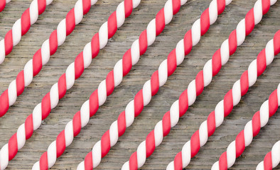 Candy caned background texture. Festive red and white candy canes on wood backdrop.