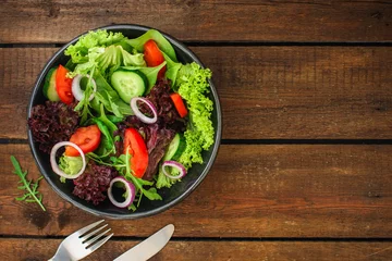 Gordijnen Healthy salad, leaves mix salad (mix micro greens, cucumber, tomato, onion, other ingredients). food background. copy space © Alesia Berlezova