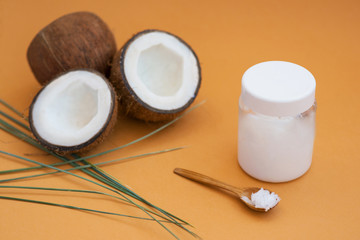 coconut oil on a poor background with coconut fruit for cosmetology and skin hydration