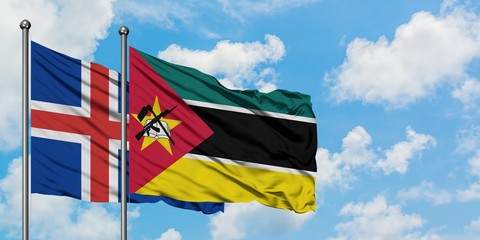 Iceland and Mozambique flag waving in the wind against white cloudy blue sky together. Diplomacy concept, international relations.