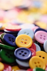 Large Group Of Colorful Plastic Sewing Buttons On Table