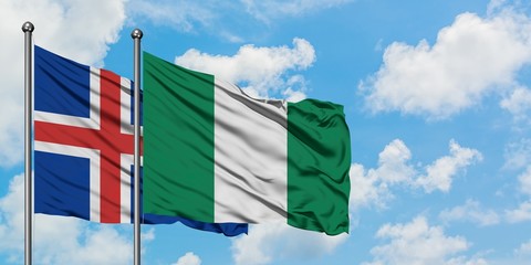 Iceland and Nigeria flag waving in the wind against white cloudy blue sky together. Diplomacy concept, international relations.