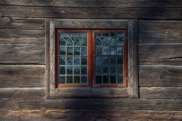 Fototapeta na wymiar Window in a old wooden house in Stockholm