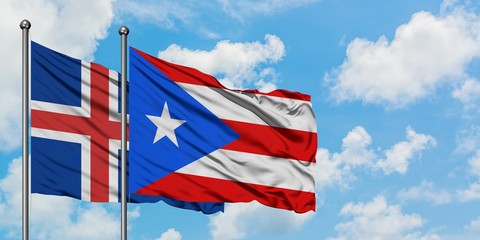 Iceland and Puerto Rico flag waving in the wind against white cloudy blue sky together. Diplomacy concept, international relations.