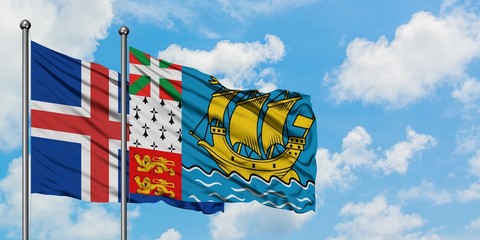 Iceland and Saint Pierre And Miquelon flag waving in the wind against white cloudy blue sky together. Diplomacy concept, international relations.