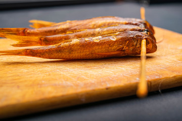 Dried mullet on a wooden Board on the table. Fish and seafood cuisine. Tasty snack.