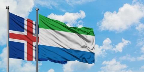 Iceland and Sierra Leone flag waving in the wind against white cloudy blue sky together. Diplomacy concept, international relations.