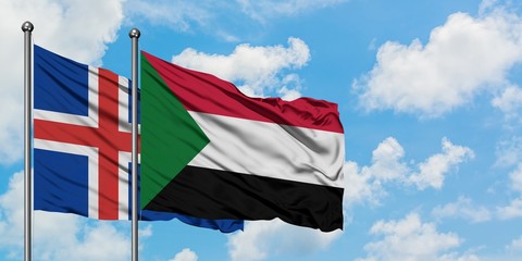 Iceland and Sudan flag waving in the wind against white cloudy blue sky together. Diplomacy concept, international relations.