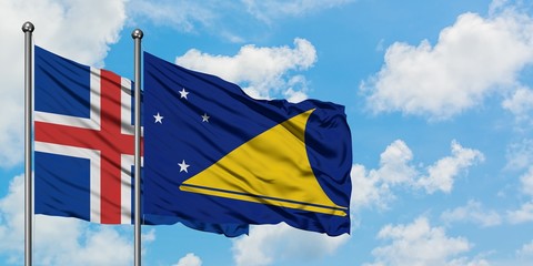 Iceland and Tokelau flag waving in the wind against white cloudy blue sky together. Diplomacy concept, international relations.