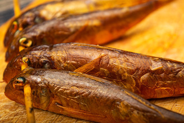 Dried mullet on a wooden Board on the table. Fish and seafood cuisine. Tasty snack. Close up.
