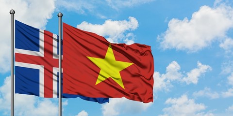 Iceland and Vietnam flag waving in the wind against white cloudy blue sky together. Diplomacy concept, international relations.