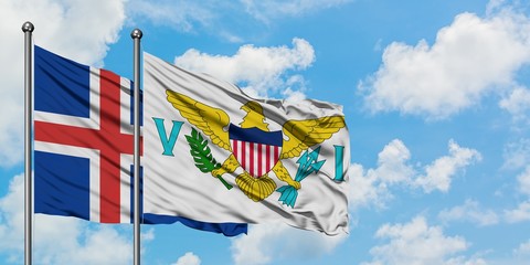 Iceland and United States Virgin Islands flag waving in the wind against white cloudy blue sky together. Diplomacy concept, international relations.