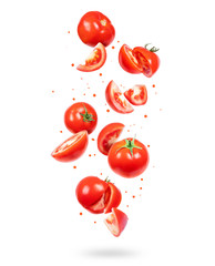 Whole and sliced fresh tomatoes in the air on a white background