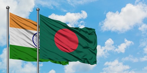 India and Bangladesh flag waving in the wind against white cloudy blue sky together. Diplomacy concept, international relations.