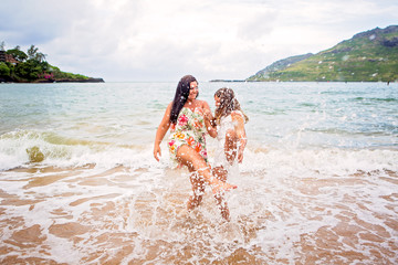 Mother and daughter playing in the Pacific Ocean