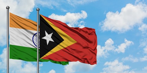 India and East Timor flag waving in the wind against white cloudy blue sky together. Diplomacy concept, international relations.