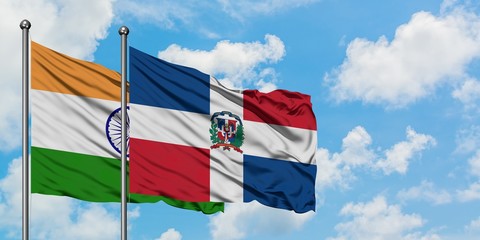 India and Dominican Republic flag waving in the wind against white cloudy blue sky together. Diplomacy concept, international relations.