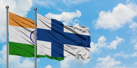 India and Finland flag waving in the wind against white cloudy blue sky together. Diplomacy...