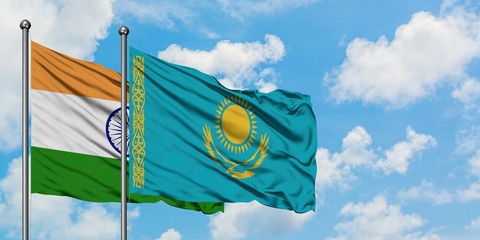 India and Kazakhstan flag waving in the wind against white cloudy blue sky together. Diplomacy concept, international relations.