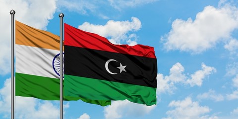 India and Libya flag waving in the wind against white cloudy blue sky together. Diplomacy concept, international relations.