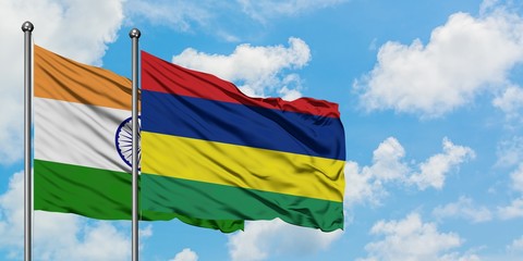 India and Mauritius flag waving in the wind against white cloudy blue sky together. Diplomacy concept, international relations.