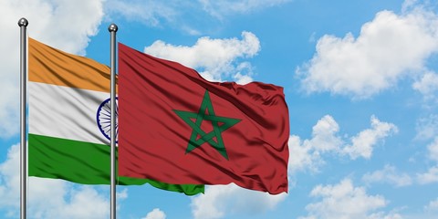 India and Morocco flag waving in the wind against white cloudy blue sky together. Diplomacy concept, international relations.