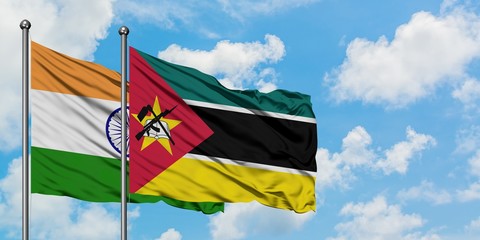 India and Mozambique flag waving in the wind against white cloudy blue sky together. Diplomacy concept, international relations.