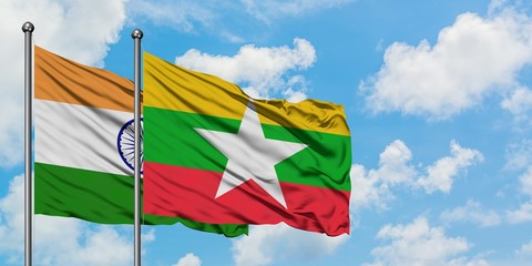 India and Myanmar flag waving in the wind against white cloudy blue sky together. Diplomacy concept, international relations.