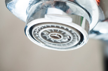 Leaking tap with a dripping drop of water. Call plumbing to eliminate leaks.