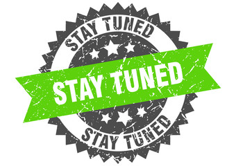 stay tuned grunge stamp with green band. stay tuned