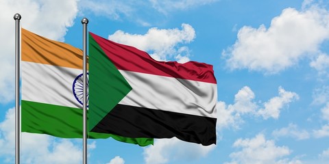 India and Sudan flag waving in the wind against white cloudy blue sky together. Diplomacy concept, international relations.