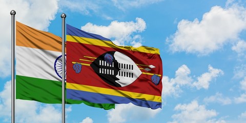 India and Swaziland flag waving in the wind against white cloudy blue sky together. Diplomacy concept, international relations.
