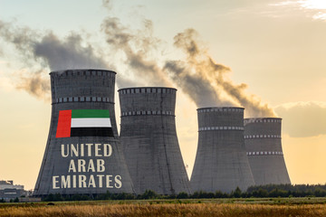 Nuclear plant chimneys displaying flag of United Arab Emirates with according text. Energy...