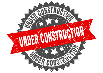 under construction grunge stamp with red band. under construction
