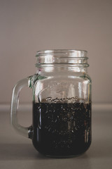 sweet carbonised soft drink in the glass isolated on grey background
