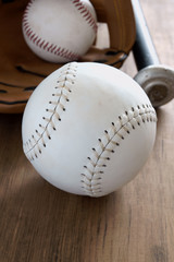 Old well used baseball with mitt and bat