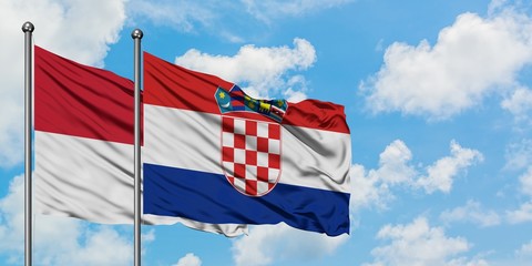 Iraq and Croatia flag waving in the wind against white cloudy blue sky together. Diplomacy concept, international relations.