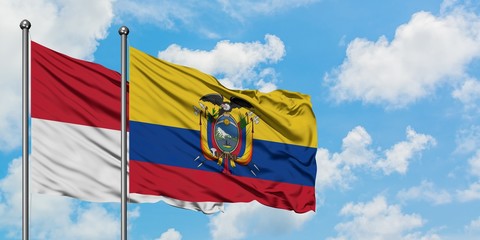 Iraq and Ecuador flag waving in the wind against white cloudy blue sky together. Diplomacy concept, international relations.